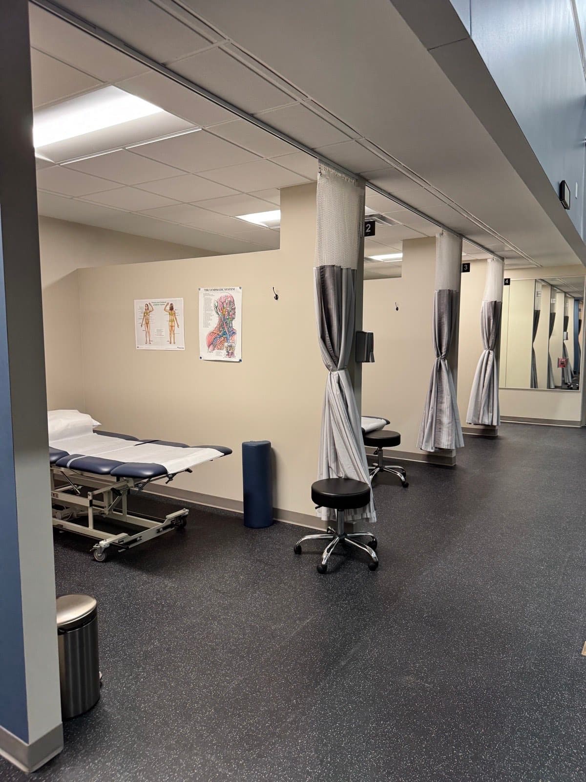 Private curtained treatment rooms with therapy tables at the LORC clinic in Orland Park